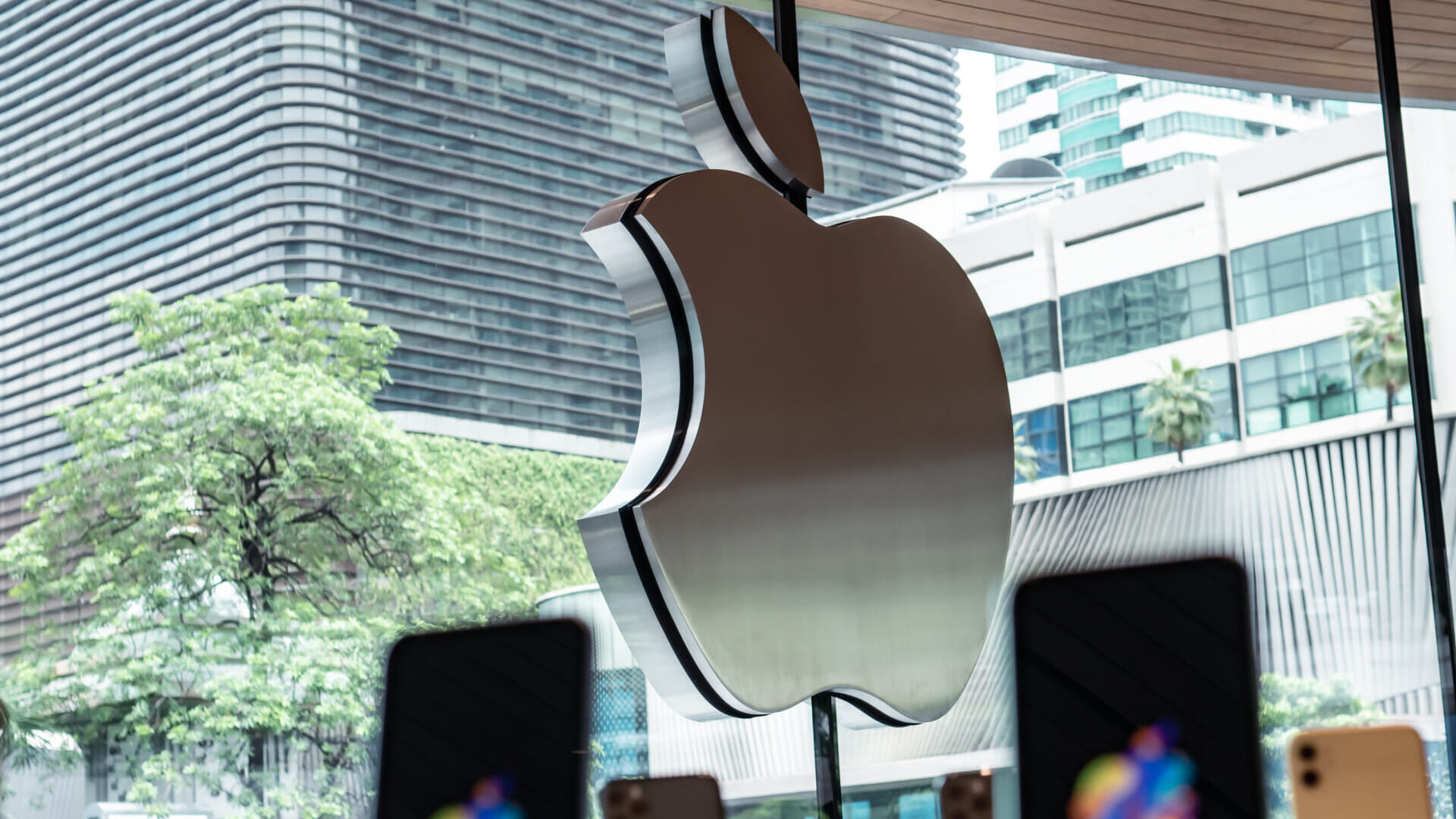 Bangkok, Thailand - September 14, 2020 : The Apple logo on Apple Store in Bangkok with iPhones in the foreground.
